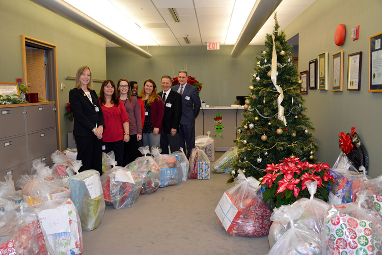 Deborah Heart and Lung Center staff posing next to collected holiday gifts.