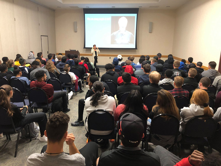 Elizabeth Manner, LCSW, LCADC giving a lecture to Raritan Valley Community College athletes on the dangers of vaping and opioids.