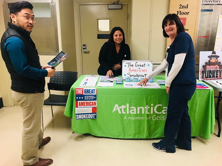 AtlantiCare employees posing at table for the Great American Smokeout.