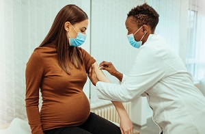 Pregnant woman treated by female doctor.