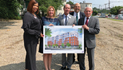 Supportive Housing: Group of people holding apartment building image.