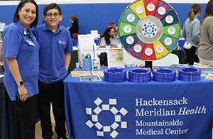 Hackensack Meridian Health representatives with a spinning wheel game.